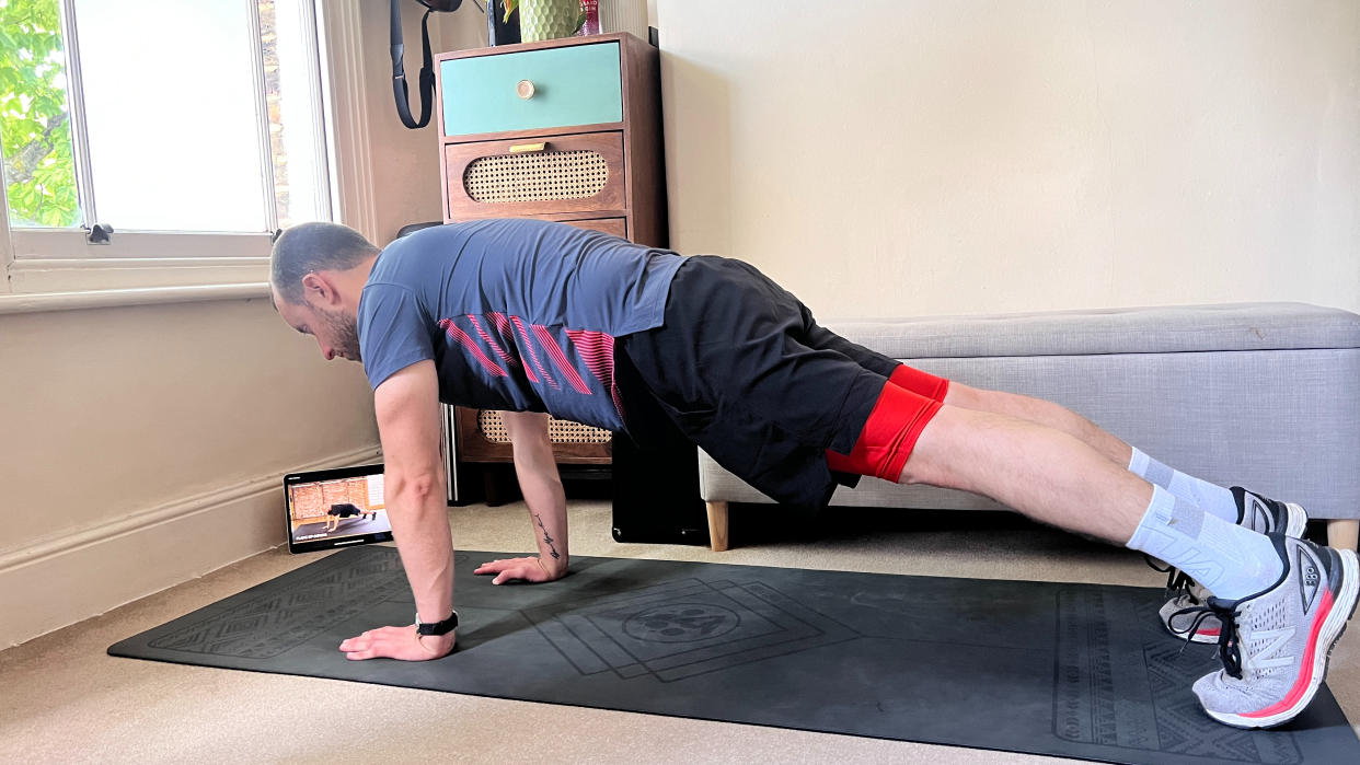  James Frew holding plank position during a Centr workout 
