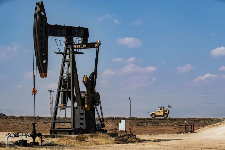 a us military vehicle, part of a convoy arriving from northern iraq, drives past an oil pump jack in the countryside of syrias northeastern city of qamishli on october 26, 2019 photo by delil souleiman  afp photo by delil souleimanafp via getty images