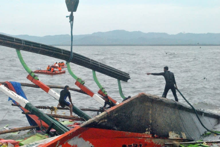 Rescuers prepare to lift the Kim Nirvana ferry after it was towed to the pier in Ormoc City, central Philippines on July 3, 2015, a day after it capsized