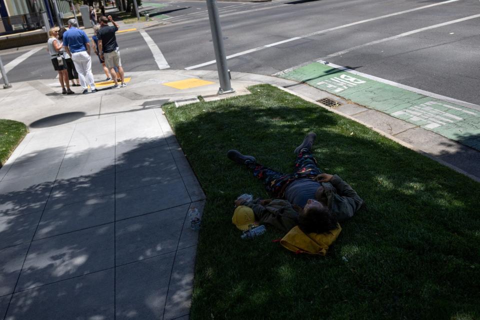 A person took a break in the shade of a sidewalk as temperatures were expected to soar above 100 degrees during the summer's first heat, in Sacramento, California, U.S., on June 4, 2024. REUTERS/Carlos Barria/File Photo