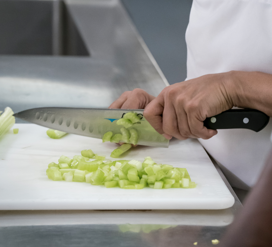 Tina chops celery with a tried-and-true Mac knife, what Roeper refers to as a “workhorse knife.”