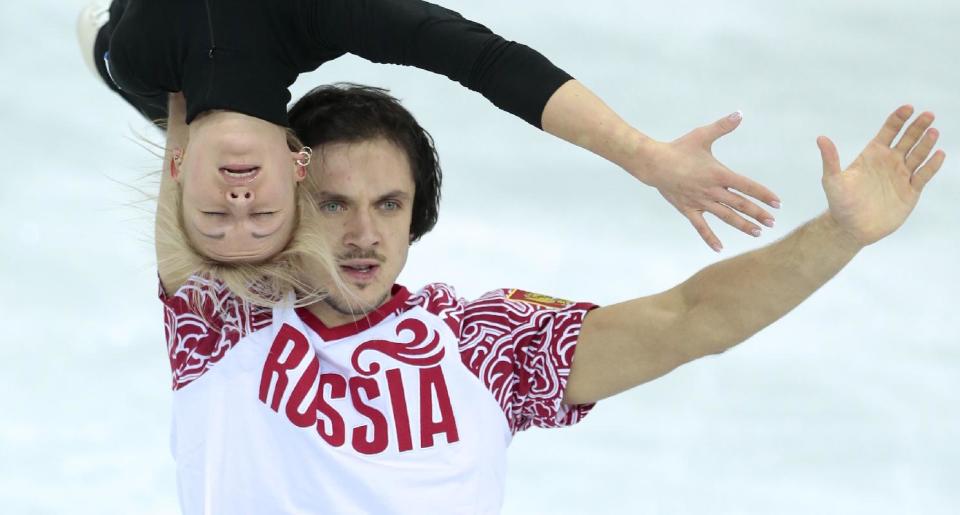 Russia's Tatiana Volosozhar and Maxim Trankov practice their routine at the figure stating practice rink ahead of the 2014 Winter Olympics, Wednesday, Feb. 5, 2014, in Sochi, Russia. (AP Photo/Ivan Sekretarev)