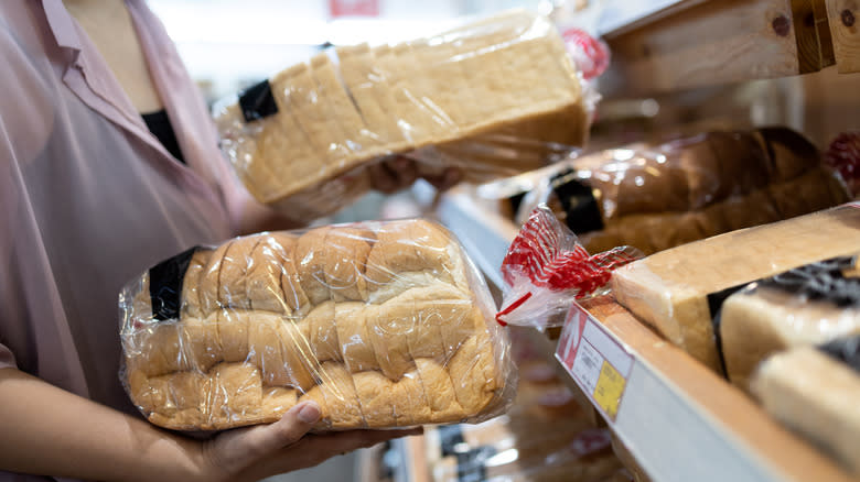 Woman holding two bread loaves