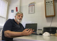 Armando Schiaffino, a native son and the island’s doctor for some 40 years now, talks with the Associated Press during an interview in his studio at the Giglio Island, Italy, Tuesday, June 23, 2020. Italian scientist Paola Muti was stranded on the tiny island where mainlanders sick with COVID-19 came ashore but no islanders apparently took ill. So she decided to do a scientific study to find out why. (AP Photo/Paolo Santalucia)