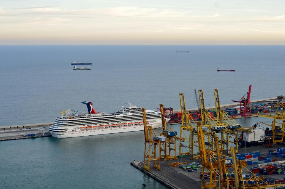 These are the top cruise lines that dock at the Barcelona cruise port. Cruisers have plenty of options to choose from for their trip to Spain. 
Pictured: The Barcelona cruise port with a Carnival cruise ship docked on s bright day 