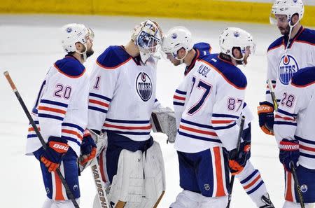 Edmonton Oilers goalie Laurent Brossoit (1) gets thanked by Oilers left winger Taylor Hall (4) after the game against San Jose Sharks at Rexall Place. Sharks won 3-1. Mandatory Credit: Walter Tychnowicz-USA TODAY Sports