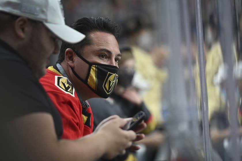 Former boxer Oscar De La Hoya watches Game 2 of a first-round NHL hockey playoff series between the Vegas Golden Knights and the Minnesota Wild on Tuesday, May 18, 2021, in Las Vegas. (AP Photo/David Becker)