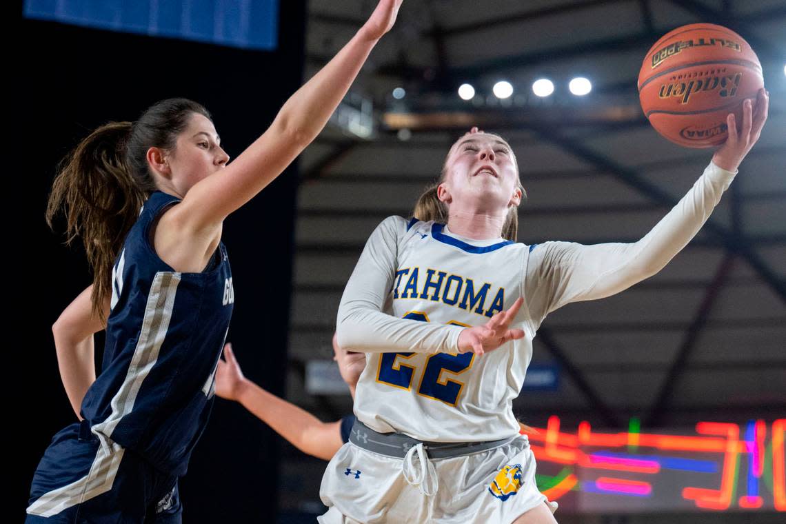 Tahoma guard Angelina Cavanaugh (22) drives tot he basket as Gonzaga Prep guard Lucy Lynn (10) defends during the third quarter of a Class 4A quarterfinal game on Thursday, March 2, 2023, in Tacoma, Wash.