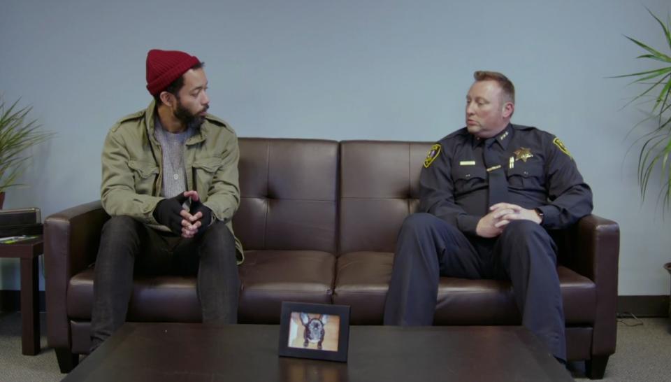 Cenac sits with a police chief from Elgin, Illinois, in Season One of "Problem Areas" on HBO. (Photo: HBO)