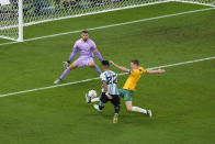 Argentina's Lautaro Martinez, left, shoots the ball next to Australia's Kye Rowles, right, and Australia's goalkeeper Mathew Ryan during the World Cup round of 16 soccer match between Argentina and Australia at the Ahmad Bin Ali Stadium in Doha, Qatar, Saturday, Dec. 3, 2022. Argentina won 2-1. (AP Photo/Manu Fernandez)