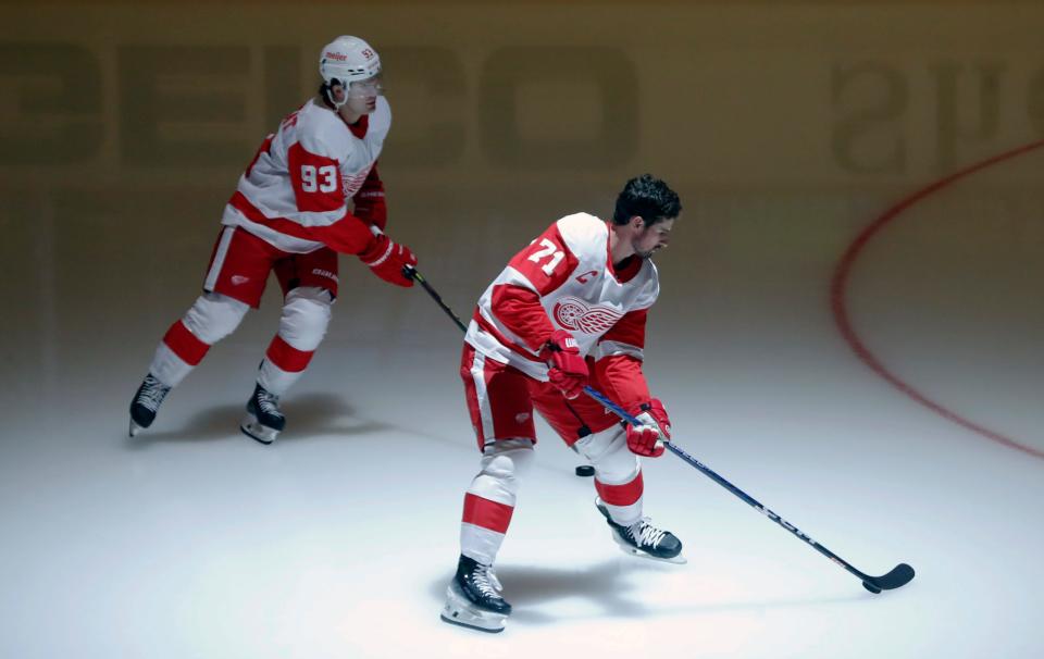 Detroit Red Wings right wing Alex DeBrincat (93) and center Dylan Larkin (71) takes the ice to warm up before the game against the Pittsburgh Penguins at PPG Paints Arena in Pittsburgh on Wednesday, Oct. 4, 2023.