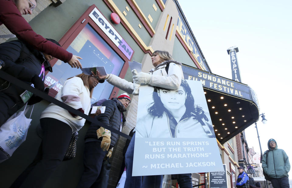 A protester hands out pamphlets to attendees at the documentary's premiere Friday at the Sundance Film Festival. (Photo: Danny Moloshok/Invision/AP)