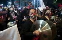 People play instruments at Plaza Italia on the day Chileans vote in a referendum to decide whether the country should replace its 40-year-old constitution, written during the dictatorship of Gen. Augusto Pinochet, in Santiago, Chile, Sunday, Oct. 25, 2020. (AP Photo/Esteban Felix)