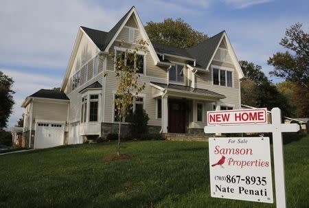 A real estate sign advertising a new home for sale is pictured in Vienna, Virginia, outside of Washington, October 20, 2014. REUTERS/Larry Downing