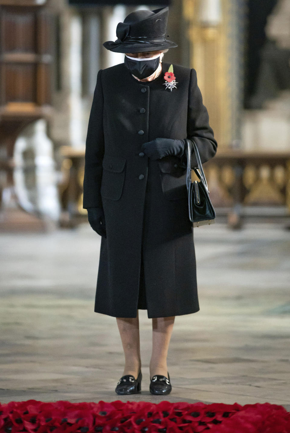 Britain's Queen Elizabeth II attends a ceremony to mark the centenary of the burial of the Unknown Warrior, in Westminster Abbey, London, Wednesday, Nov. 4, 2020. Queen Elizabeth II donned a face mask in public for the first time during the coronavirus pandemic when attending a brief ceremony at Westminster Abbey last week to mark the centenary of the burial of the Unknown Warrior. While the 94-year-old has been seen in public on several occasions over the past few months, she has not worn a face covering. (Aaron Chown/Pool Photo via AP)