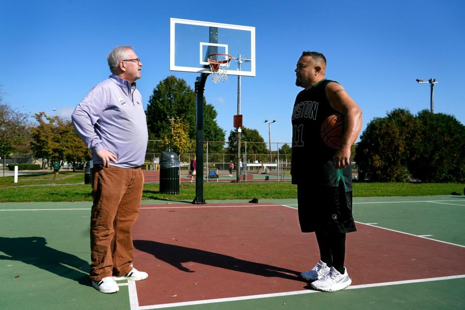 James L. Lathrop, Republican candidate for general treasurer,  chats with Luis Ortiz on the basketball court at Wilson Park in Wickford on Sunday.