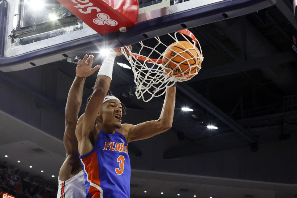 Florida forward Alex Fudge slam dunks the ball against Auburn during the first half of an NCAA basketball game Wednesday, Dec. 28, 2022, in Auburn, Ala. (AP Photo/Butch Dill)