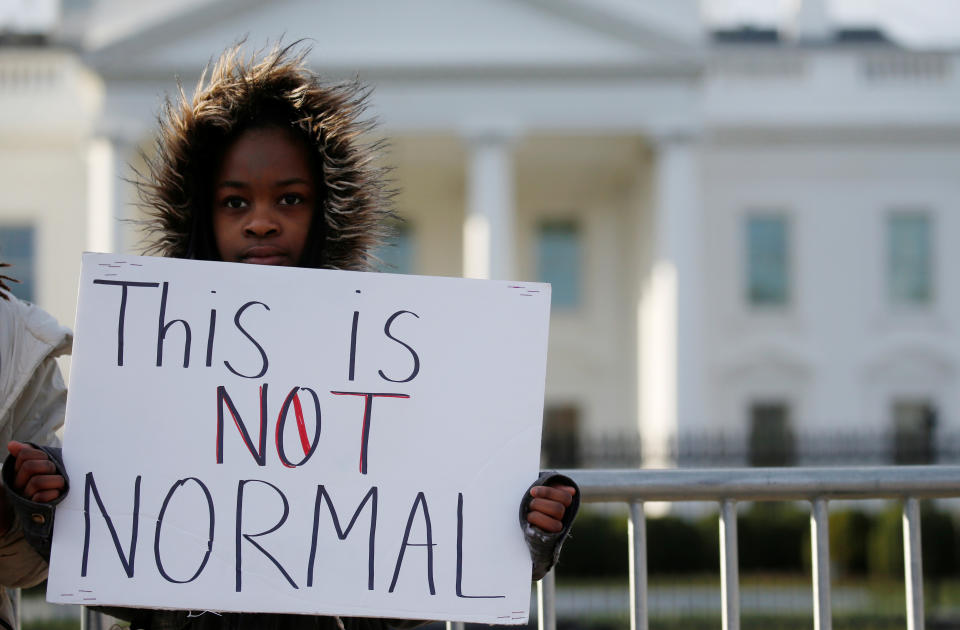 Kashyia Smith, 12, of Wisconsin, holds a sign saying: This Is Not Normal.