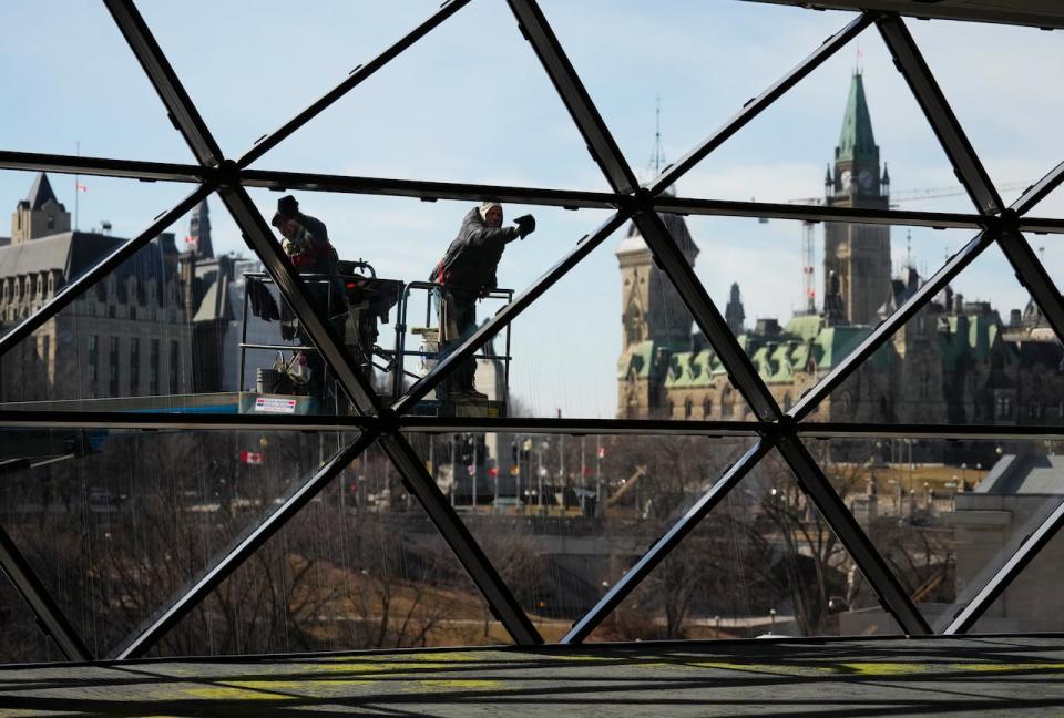 Window washers work at the Shaw Centre in downtown Ottawa on March 8, 2024.