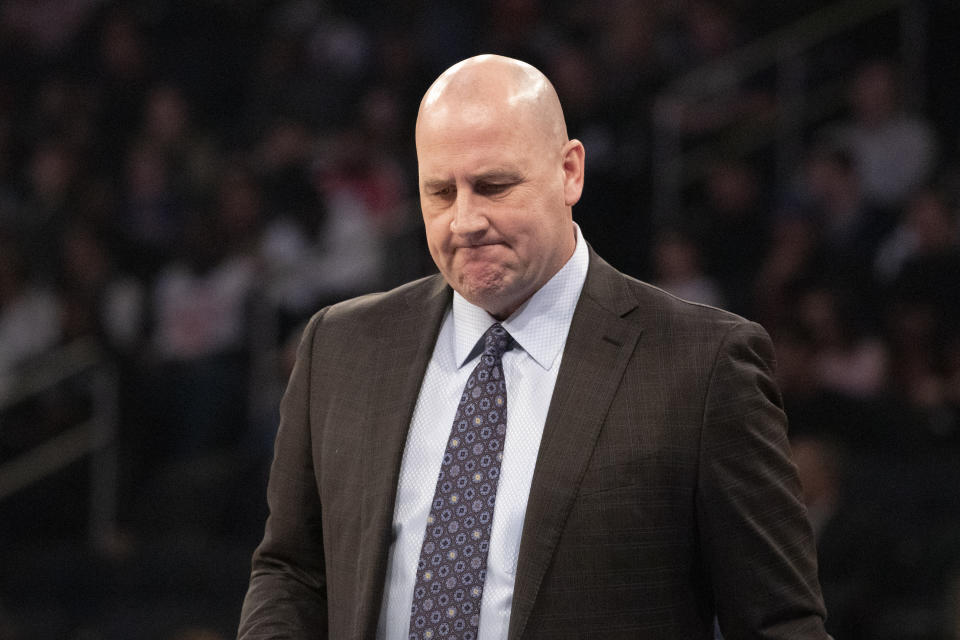 Jim Boylen in a suit and tie with distressed face.