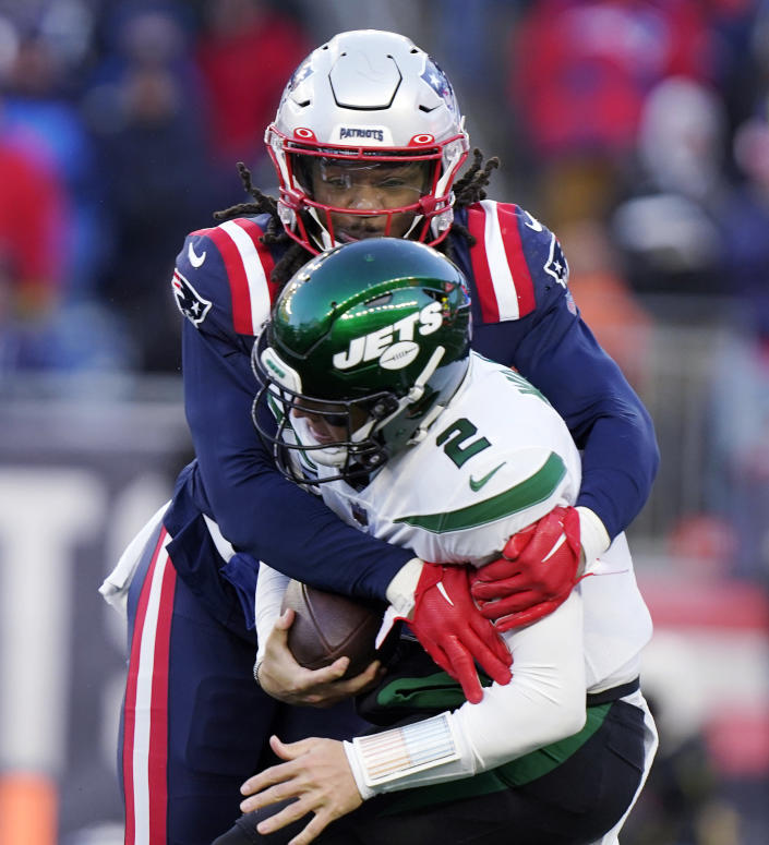 New England Patriots safety Kyle Dugger, top, sacks New York Jets quarterback Zach Wilson (2) during the second half of an NFL football game, Sunday, Nov. 20, 2022, in Foxborough, Mass. (AP Photo/Steven Senne)