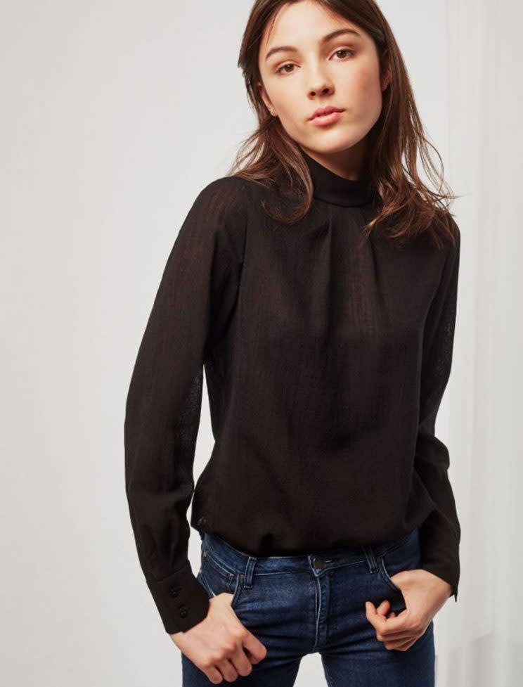 A model in a black high neck long-sleeve blouse. (Photo: Cefinn)