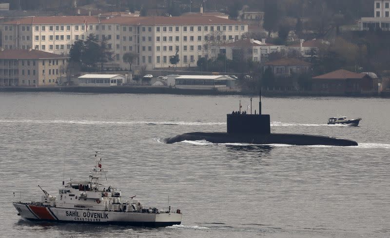 Russia's diesel-electric submarine Rostov-on-Don is escorted by a Turkish Navy Coast Guard boat as it sets sail in the Bosphorus, on its way to the Black Sea, in Istanbul, Turkey, December 13, 2015. REUTERS/Murad Sezer 