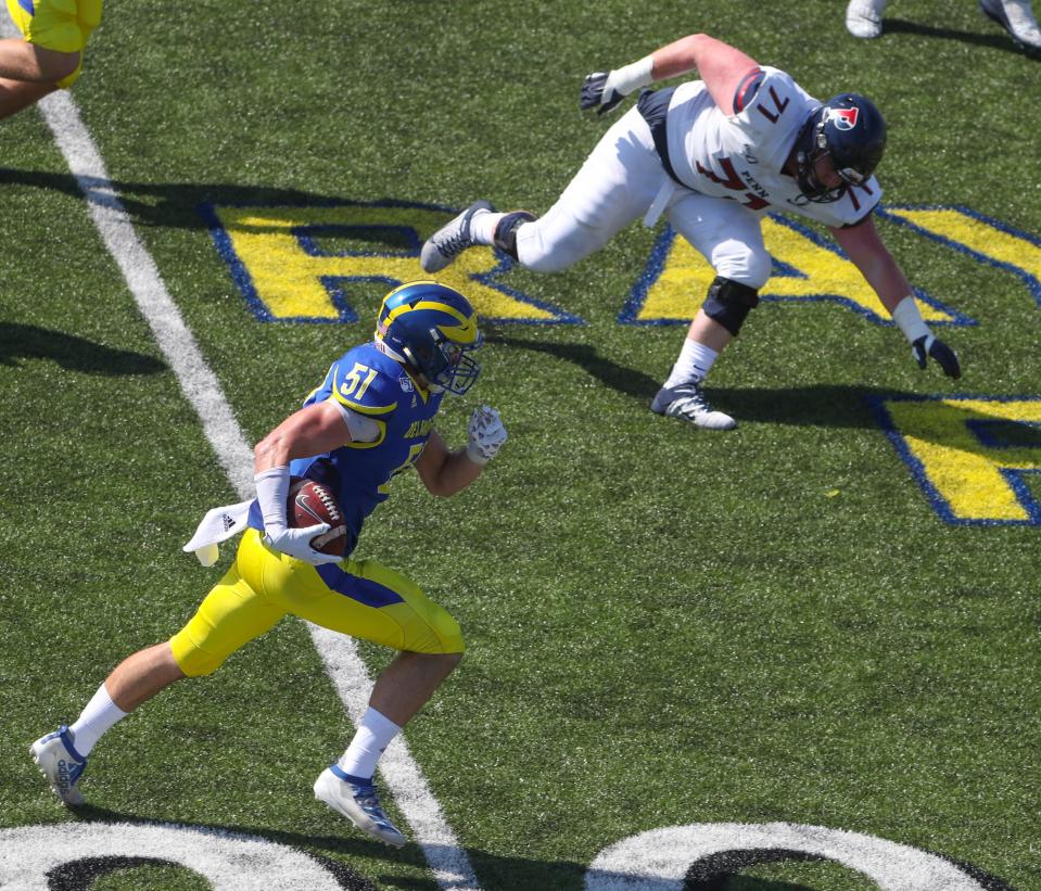 Delaware's Drew Nickles takes off with an interception return as Penn's Greg Begnoche tries to reverse direction to pursue in the second quarter at Delaware Stadium in 2019.