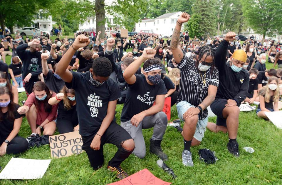 Joshua Stewart, 19, left, Aaron Lorenzo, 23, Isaiah Stewart, 24, and Leonardo Amaro Jr., 19, all of Colchester, join 400 to 500 people on the Colchester Town Green June 5, 2020, in a Black Lives Matters protest in memory of George Floyd.
