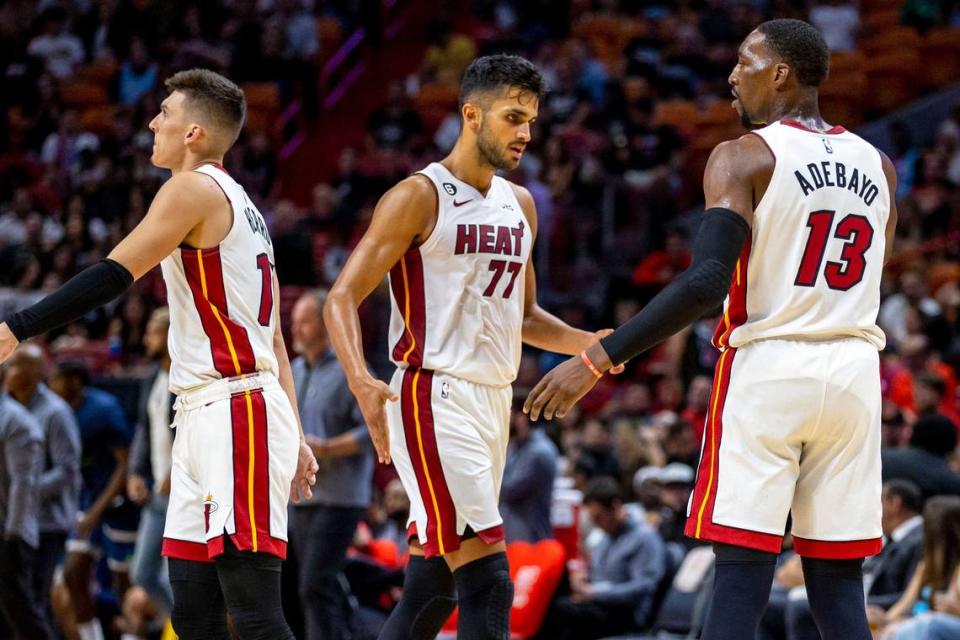 Miami Heat center Bam Adebayo (13) low-fives center Omer Yurtseven (77) during the first half of an NBA preseason basketball game against the Minnesota Timberwolves at FTX Arena in Miami, Florida, on Tuesday, October 4, 2022.