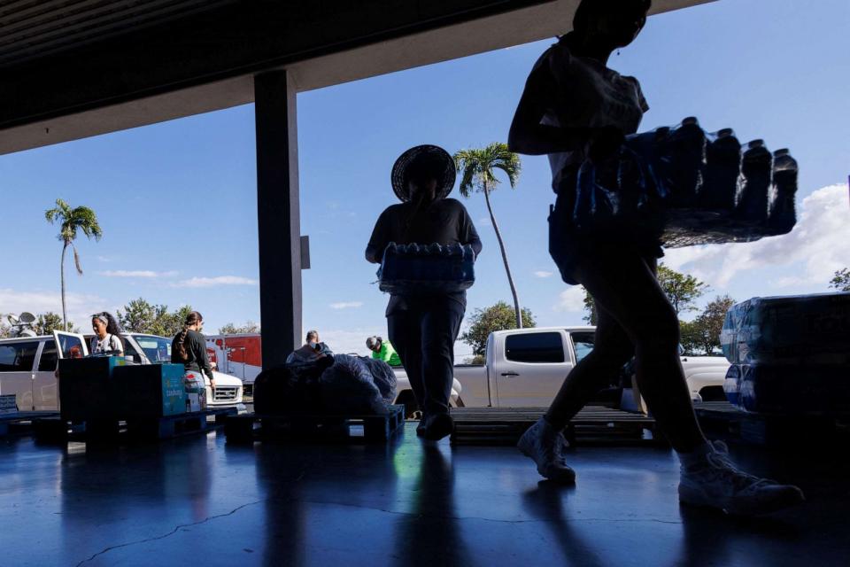 PHOTO: Volunteers help with community donations of drinking water at King's Cathedral church as residents come together to help people effected by the wildfires on Maui island, in Hawaii, U.S., August 11, 2023. (Mike Blake/Reuters)
