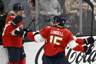 Florida Panthers center Sam Reinhart, left, celebrates scoring against the Anaheim Ducks with center Anton Lundell, right, and left wing Ryan Lomberg during the third period of an NHL hockey game in Anaheim, Calif., Sunday, Nov. 6, 2022. (AP Photo/Alex Gallardo)