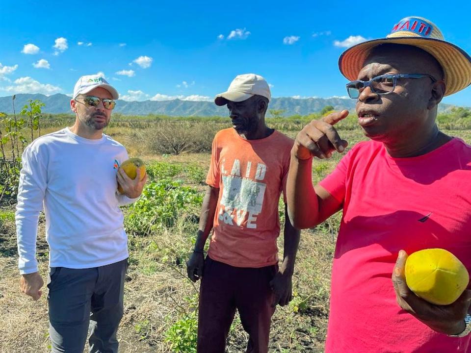 From left to right: Geoffrey Handal, farmer Fransik Monchèr and Maxwell Marcelin. Handal and Marcelin, who formed the company AGRILOG, are working with farmers like Monchèr in northern Haiti to help them improve techniques for growing peppers and other produce.