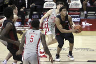 San Diego State's Matt Mitchell (11) drives past UNLV's Caleb Grill (3) during the second half of an NCAA college basketball game Wednesday, March 3, 2021, in Las Vegas. (AP Photo/Joe Buglewicz)