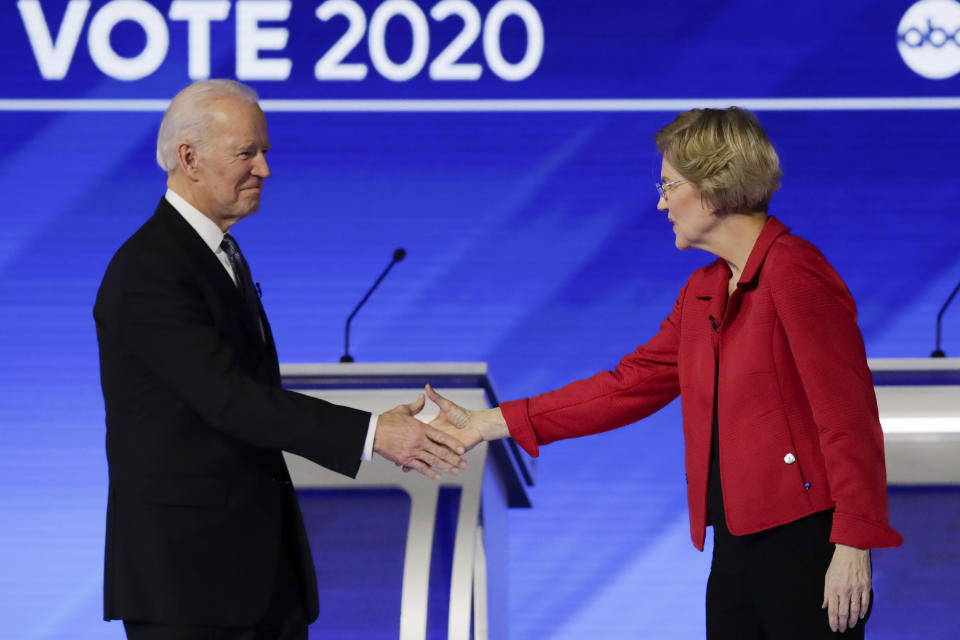 FILE- In this Feb. 7, 2020 file photo, Democratic presidential candidates former Vice President Joe Biden, and Sen. Elizabeth Warren, D-Mass., shake hands on stage before the start of a Democratic presidential primary debate hosted by ABC News, Apple News, and WMUR-TV at Saint Anselm College in Manchester, N.H. Warren has endorsed Joe Biden, becoming the last of the former vice president’s major Democratic presidential rivals to formally back him.(AP Photo/Charles Krupa)