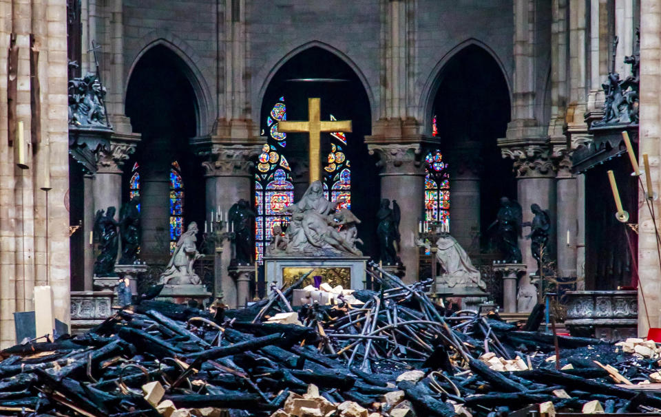 Blackened remains of Notre Dame's wooden roof framework lie on the cathedral floor. (Photo: POOL New / Reuters)