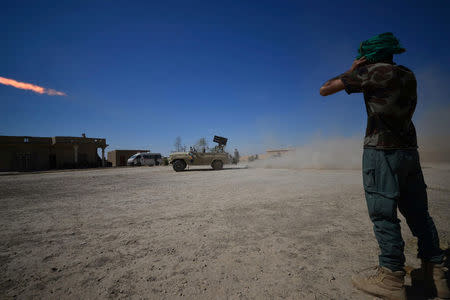 Shi'ite Popular Mobilization Forces (PMF) fire a rocket towards Islamic State militants in Al-Al-Fateha military airport south of Hawija, Iraq, October 2, 2017. REUTERS/Stringer