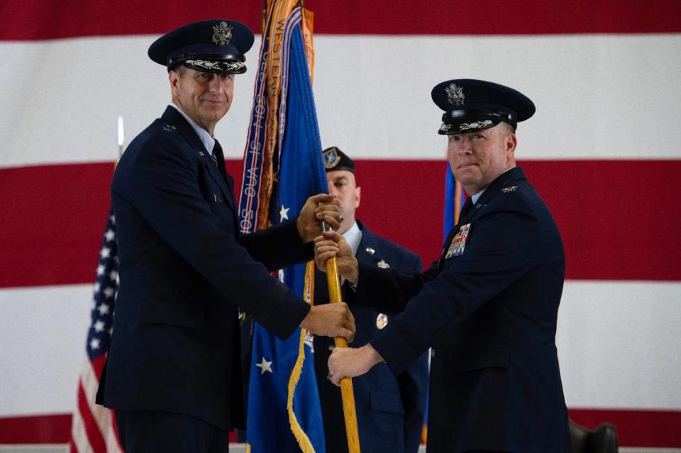 U.S. Air Force Col. John Poole, right, 375th Air Mobility Wing commander, assumes command of the 375th AMW after receiving the Wing’s guidon from Maj. Gen. Corey Martin, 18th Air Force commander, on Scott Air Force Base. The change of command ceremony represents a time-honored military tradition providing an opportunity for Airmen to witness the transfer of power to their newly appointed commanding officer. Staff Sgt. Dalton Williams/U.S. Air Force/375th Air Mobility Wing Public Affairs