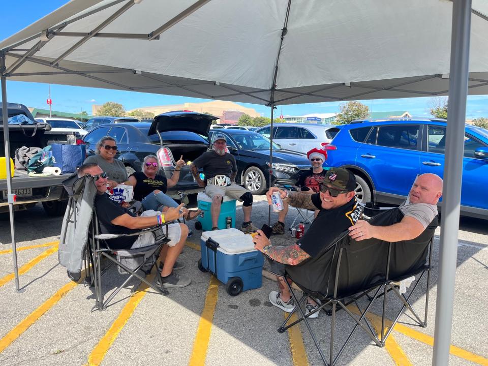 As thousands of people made their way into the Highlands Festival Grounds on Sunday for the final day of Louder Than Life, some music lovers, like the ones pictured here, set up mini tailgating areas surrounding the venue.