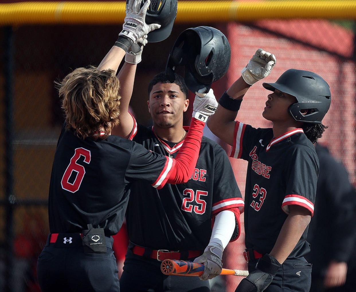 Woodbridge baseball players Drew Lukachyk (6), Xavier Diaz (25) and Derek Anderson (23) celebrate during a win over Edison on May 1, 2023