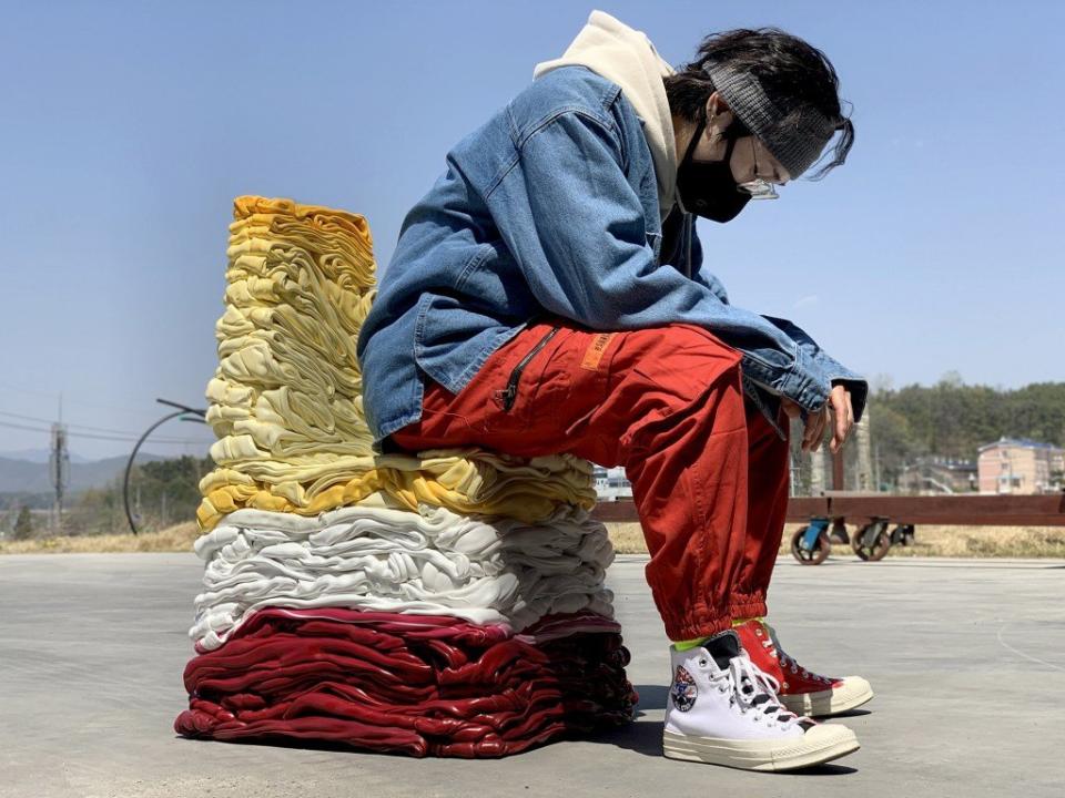 Artist Youngmin Kang sits on one of his sculptural repurposed chairs. 