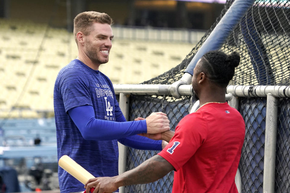 Los Angeles Dodgers' Freddie Freeman, left, greets Atlanta Braves' Ozzie Albies prior to a baseball game Monday, April 18, 2022, in Los Angeles. (AP Photo/Mark J. Terrill)