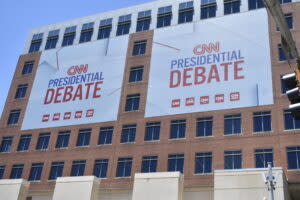  Banners hang on Tuesday, June 25, 2024, from Turner Broadcasting’s Midtown Atlanta headquarters, where the CNN televised presidential debate is set to take place Thursday. (Photo by Ross Williams/Georgia Recorder)