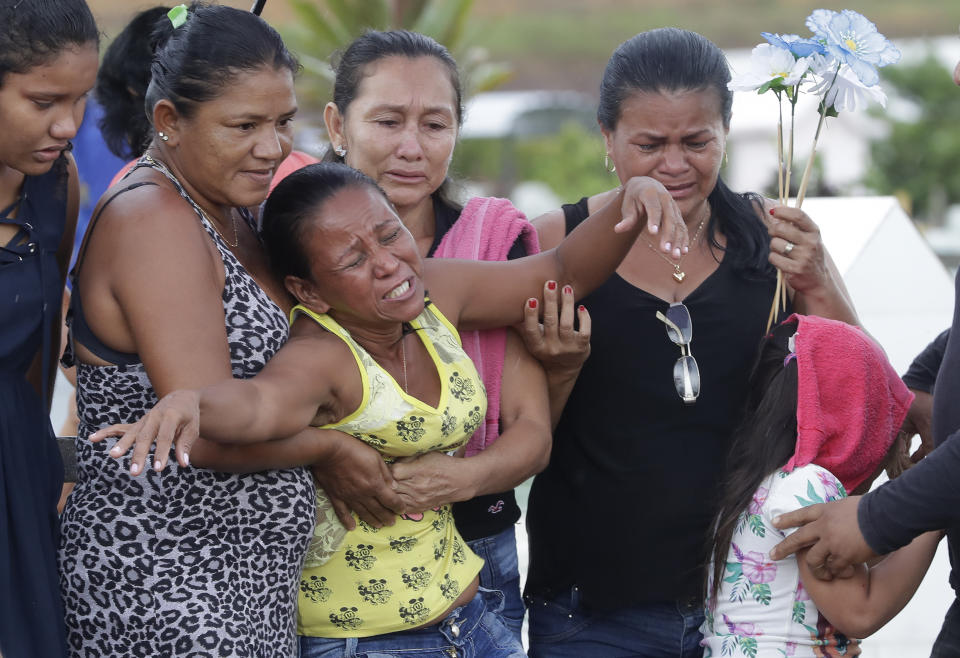 Antonia Alves grieves as she is comforted by relatives during the burial of her son Jairo Alves Figueiredo, an inmate who was killed in the recent prison riots, at a cemetery in Manaus, Brazil, Thursday, May 30, 2019. Families were burying victims of several prison riots in which dozens of inmates died in the northern Brazilian state of Amazonas, as authorities confirmed they had received warnings of an “imminent confrontation” days before the attacks begun. (AP Photo/Andre Penner)