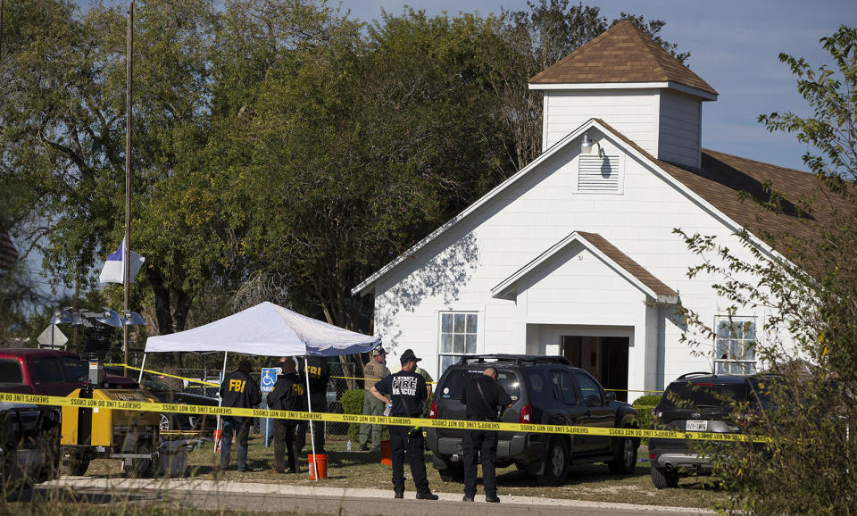 Investigators work at the scene of the mass shooting at First Baptist Church in Sutherland Springs, Texas, on Sunday. (Nick Wagner/Austin American-Statesman vía AP)