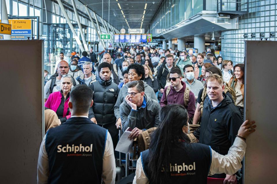 Travelers wait in a departure hall at Schiphol airport, near Amsterdam, a day after a strike by KLM luggage handlers caused many flights to be canceled, on April 24, 2022.