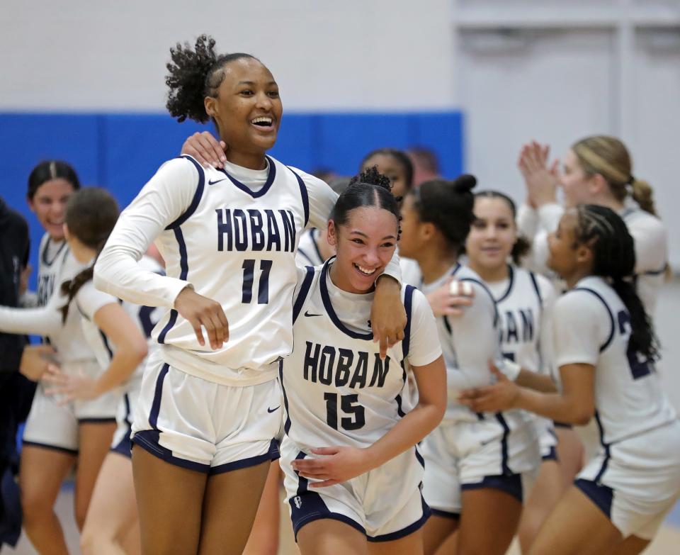 Hoban forward Devin Harris, left, and guard Mackenzie Edingburgh celebrate after beating Ellet in a Division I district semifinal, Tuesday, Feb. 27, 2024, in Ravenna.