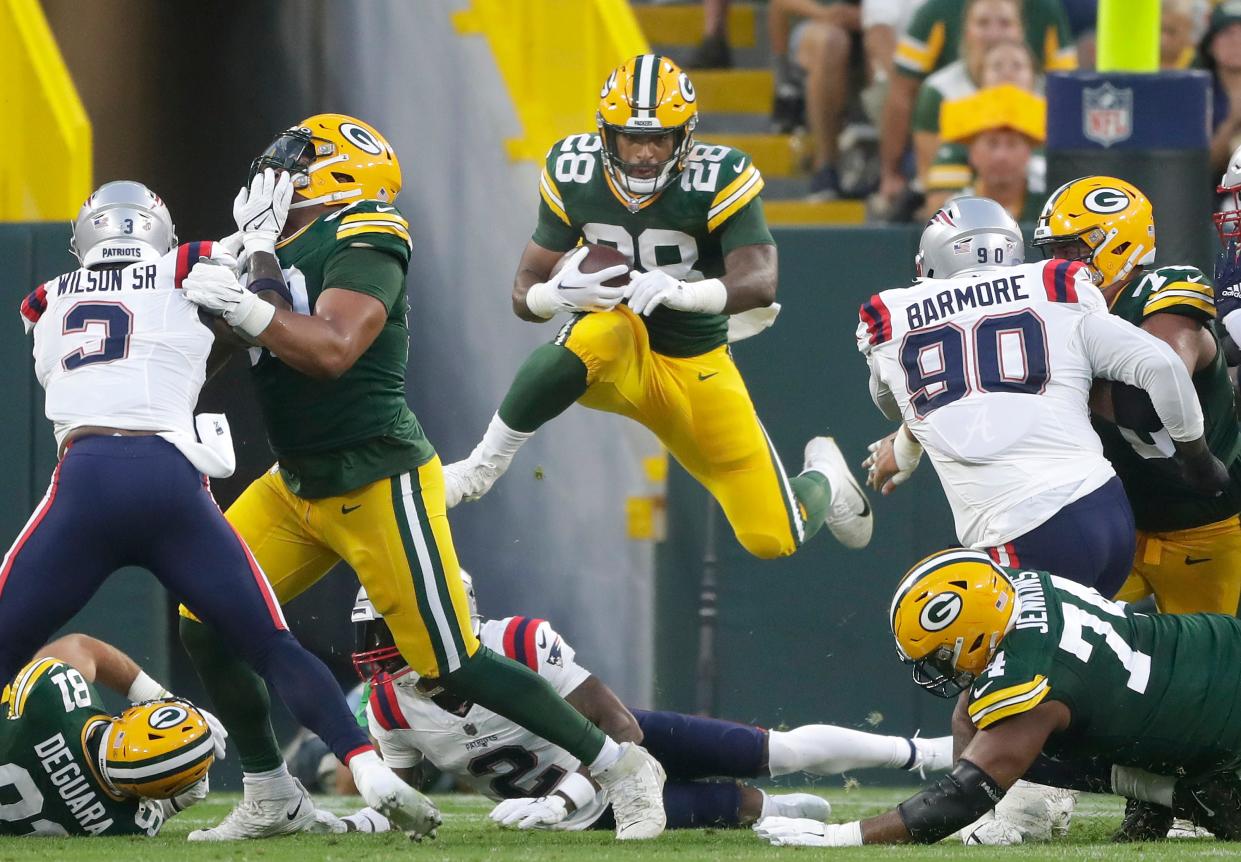 Green Bay Packers running back AJ Dillon rushes in the first quarter against the New England Patriots during their preseason game Aug. 19, 2023, at Lambeau Field in Green Bay.