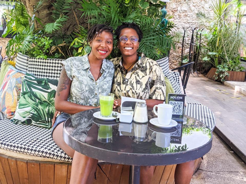 Amber and her partner posing at an outdoor restaurant