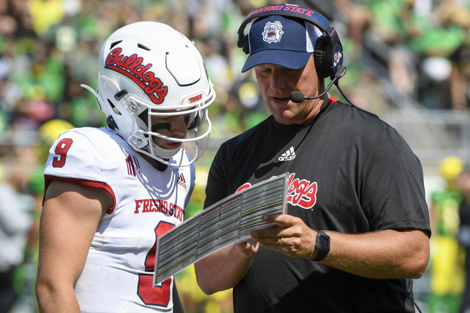 Fresno State quarterback Jake Haener (9) talks with head coach Kalen DeBoer during the third quarter of an NCAA college football game against Oregon, Saturday, Sept. 4, 2021, in Eugene, Ore. (AP Photo/Andy Nelson)